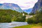 Skjolden, Norway. Sognefjord, white steeple church in village. Art Print